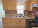 Bright kitchen boasts wood cabinets, durable countertops, and a dual-basin sink at 5014 Galaxy Dr, New Port Richey, FL 34652