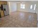 Open floor plan features tile flooring, a ceiling fan, and a window offering natural light at 5014 Galaxy Dr, New Port Richey, FL 34652