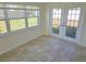 Sunroom featuring tile flooring, natural light, and access to the backyard at 5014 Galaxy Dr, New Port Richey, FL 34652