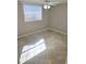 Corner bedroom with window and tile floor, offering ample natural light at 6014 Cecelia Dr, New Port Richey, FL 34653