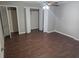 A well-lit bedroom with vinyl floors, ceiling fan and a closet with folding doors at 6014 Cecelia Dr, New Port Richey, FL 34653