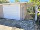 A view of the property's garage, featuring a gate and stone pavers at 6014 Cecelia Dr, New Port Richey, FL 34653