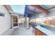 Covered porch overlooking backyard including outdoor grill and bar at 671 Roanoke Rd, Venice, FL 34293