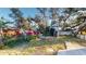 Spacious backyard featuring a wooden deck, mature trees, and partial fencing for privacy at 671 Roanoke Rd, Venice, FL 34293