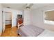 This cozy bedroom features a ceiling fan, wood floors, and a window with natural light at 671 Roanoke Rd, Venice, FL 34293