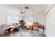 Bedroom with natural light, ceiling fan, windows, and assorted furniture pieces at 671 Roanoke Rd, Venice, FL 34293