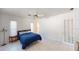 Bright bedroom with light tile floors, a ceiling fan, and natural light from two windows at 671 Roanoke Rd, Venice, FL 34293