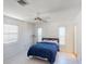 Simple bedroom with a cozy bed, tile floors, and bright natural light streaming through large windows at 671 Roanoke Rd, Venice, FL 34293
