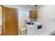 A laundry room with washer, dryer, and wood accents at 671 Roanoke Rd, Venice, FL 34293