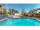 Backyard with a refreshing in-ground swimming pool and lush greenery around the perimeter at 671 Roanoke Rd, Venice, FL 34293