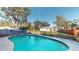 Enjoy a backyard pool surrounded by lush greenery and a charming stone border at 671 Roanoke Rd, Venice, FL 34293