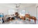 Room with two windows, white walls, concrete floor, and ceiling fan for natural light and ventilation at 671 Roanoke Rd, Venice, FL 34293