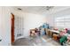 Bright room with white walls, concrete floor, ceiling fan and natural light from a large window at 671 Roanoke Rd, Venice, FL 34293
