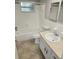 Bathroom with a tub and shower combo, single sink vanity, and tiled floor at 7352 Sequoia Dr, New Port Richey, FL 34653