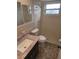 Tiled bathroom featuring a single sink vanity, toilet, and tiled walk-in shower at 7352 Sequoia Dr, New Port Richey, FL 34653