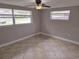 Bedroom with neutral walls, tile flooring, a ceiling fan, and a window at 7352 Sequoia Dr, New Port Richey, FL 34653