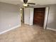 Bedroom with tile flooring, a ceiling fan, and a closet with wood paneling at 7352 Sequoia Dr, New Port Richey, FL 34653