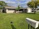 Charming single-story home with a lush front yard and a mailbox showcasing the address at 7352 Sequoia Dr, New Port Richey, FL 34653