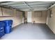 Spacious garage with epoxy flooring, overhead storage, and ample room for parking and projects at 7352 Sequoia Dr, New Port Richey, FL 34653