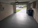 Garage with an open door offering a view of the driveway and front yard at 7352 Sequoia Dr, New Port Richey, FL 34653