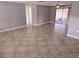 Spacious living area with neutral paint, tile floors and a screened patio with sliding glass doors at 7352 Sequoia Dr, New Port Richey, FL 34653