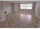 Bright living room with tiled floors, a large window, and freshly painted walls at 7352 Sequoia Dr, New Port Richey, FL 34653