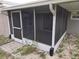 Cozy screened-in porch with ample space for seating and relaxation, enclosed with screens at 7352 Sequoia Dr, New Port Richey, FL 34653