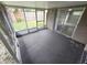 Enclosed sunroom with sliding glass doors and view of the backyard offers indoor/outdoor living at 7352 Sequoia Dr, New Port Richey, FL 34653