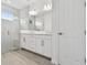 Elegant bathroom with dual sinks, marble accents, and glass-enclosed shower at 17982 Cherished Loop, Bradenton, FL 34211