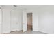 Neutral bedroom with open door and wood-look floors, leading to another room at 17982 Cherished Loop, Bradenton, FL 34211