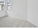 Carpeted bedroom with two windows providing natural light and street view at 17982 Cherished Loop, Bradenton, FL 34211