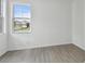 Bright bedroom features a view of the surrounding neighborhood through the windows at 17982 Cherished Loop, Bradenton, FL 34211
