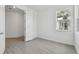 Stylish bedroom featuring natural light, luxury vinyl floors, and an open door at 17982 Cherished Loop, Bradenton, FL 34211
