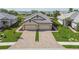 Attractive home featuring a brick driveway, lush green lawn, and mature landscaping at 17982 Cherished Loop, Bradenton, FL 34211