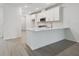Modern kitchen with white cabinets, stainless steel appliances, and a stylish breakfast bar at 17982 Cherished Loop, Bradenton, FL 34211