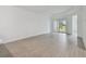 Spacious, bright living room featuring light wood-look floors and an open floor plan at 17982 Cherished Loop, Bradenton, FL 34211