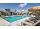 Inviting swimming pool with lounge chairs, umbrellas, and clear blue water for relaxation and enjoyment at 17982 Cherished Loop, Bradenton, FL 34211