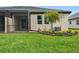 A view of the screened in patio, as well as some landscaping in the backyard at 17986 Cherished Loop, Bradenton, FL 34211