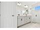 Modern bathroom features dual sinks, a glass shower, and sleek fixtures at 17986 Cherished Loop, Bradenton, FL 34211