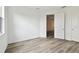 Bright bedroom with wood-look tile flooring and open doorways at 17986 Cherished Loop, Bradenton, FL 34211
