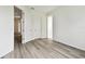 Bright bedroom featuring wood-look tile flooring and multiple doorways at 17986 Cherished Loop, Bradenton, FL 34211