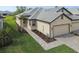 Well-maintained home featuring an attached two-car garage, lush lawn, and a brick paver walkway at 17986 Cherished Loop, Bradenton, FL 34211