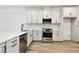 Modern kitchen featuring stainless steel appliances, white cabinets, and stylish countertops at 17986 Cherished Loop, Bradenton, FL 34211