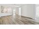 Spacious living room with wood-style flooring and open access to the kitchen and hallway at 17986 Cherished Loop, Bradenton, FL 34211