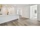 Bright and airy living space with wood-style flooring and a view into the modern kitchen at 17986 Cherished Loop, Bradenton, FL 34211