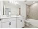Modern bathroom features a double sink vanity with white cabinets and a tiled shower-tub combo at 5421 Tripoli Dr, Palmetto, FL 34221