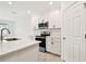 Modern kitchen with stainless appliances, white cabinets, a center island with quartz countertops and a modern faucet at 5421 Tripoli Dr, Palmetto, FL 34221