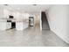 Open-concept living area with white cabinets, island, and stairway, offering a modern and spacious design at 5421 Tripoli Dr, Palmetto, FL 34221