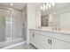Bathroom featuring a tiled shower with glass door, double sinks, and modern fixtures at 5425 Tripoli Dr, Palmetto, FL 34221