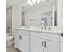 Modern bathroom features double sinks, white cabinets, matte black hardware, and a large mirror at 5425 Tripoli Dr, Palmetto, FL 34221